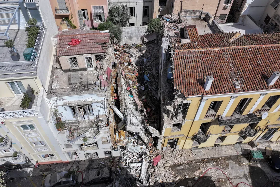 Athens building collapses after explosion kills one and leaves five missing